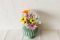 Stylish colorful wildflowers bouquet on tile shelf on rustic wall background. Beautiful summer flowers in vase gathered from Royalty Free Stock Photo