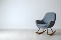 Stylish comfortable armchair near light wall