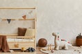 Stylish composition of cozy scandinavian child`s room interior with wooden bed, plush and wooden toys and textile hanging.