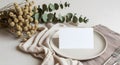Elegant table setting with blank card, eucalyptus, and dried flowers Royalty Free Stock Photo