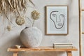 Stylish composition of living room interior with mock up poster frame, bench in retro style, clay vase and books. Rustic.