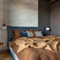 Stylish composition of modern bedroom interior. Bed, creative lamp and elegant personal accessories. Concrete wall. Brown sheeets