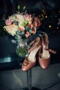 Stylish composition of wedding accessories, close-up, selective focus. Beige shoes of bride, two gold wedding rings, bouquet of Royalty Free Stock Photo