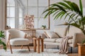 Stylish composition of modern living room interior with frotte armchair, sofa, plants, painting, wooden commode, side table. Royalty Free Stock Photo