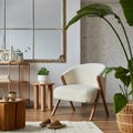 Stylish compositon of modern living room interior with frotte armchair, sofa, plants, wooden commode, side table and elegant home Royalty Free Stock Photo