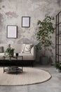 The stylish compostion at living room interior with design gray sofa, coffee table, plant, hanger, lamp and elegant personal Royalty Free Stock Photo