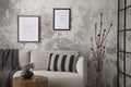 The stylish compostion at living room interior with design gray sofa, coffee table, plant, hanger, lamp and elegant personal