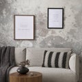 The stylish compostion at living room interior with mock up poster frame, design gray sofa, coffee table, plant, hanger, lamp and Royalty Free Stock Photo