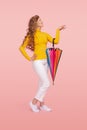 Gladful young woman in casual clothes with colorful umbrella