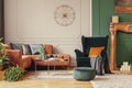 copper colored coffee table in front of comfortable corner sofa in trendy living room Royalty Free Stock Photo