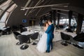 Stylish couple dancing, kissing in the modern interior of restaurant. Royalty Free Stock Photo