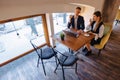 A stylish couple drinks morning coffee at the cafe and works with a laptop, young businessmen and freelancers Royalty Free Stock Photo