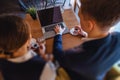 A stylish couple drinks morning coffee at the cafe and works with a laptop, young businessmen and freelancers Royalty Free Stock Photo