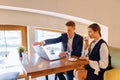 A stylish couple drinks morning coffee at the cafe and works with a laptop, young businessmen and freelancers Royalty Free Stock Photo