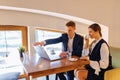 A stylish couple drinks morning coffee at the cafe and works with a laptop, young businessmen and freelancers Royalty Free Stock Photo