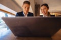 A stylish couple drinks morning coffee at the cafe and works with a laptop, young businessmen and freelancers Royalty Free Stock Photo