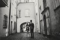 Stylish couple embracing in european city street on background of old architecture. Fashionable man and woman in love dancing with Royalty Free Stock Photo