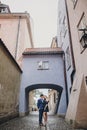 Stylish couple embracing together in european city street on background of old architecture. Fashionable man and woman in love Royalty Free Stock Photo