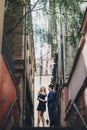 Stylish couple embracing together in european city street on background of old architecture. Fashionable man and woman in love Royalty Free Stock Photo