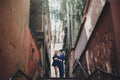 Stylish couple embracing together in european city street on background of old architecture. Fashionable man and woman in love Royalty Free Stock Photo