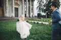 Stylish couple of happy newlyweds. Bride running from groom in the park on their wedding day Royalty Free Stock Photo