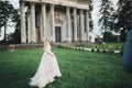 Stylish couple of happy newlyweds. Bride running from groom in the park on their wedding day Royalty Free Stock Photo