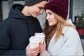 Stylish couple in love holding takeout coffee cup in hands Royalty Free Stock Photo