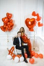 Stylish couple man and woman with balloons for Valentine`s day