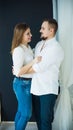 Stylish couple-man and woman in white shirts and jeans hugging. photo in bright colors