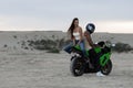 Stylish couple on motorbike on beach