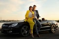 Stylish couple near luxury convertible car Royalty Free Stock Photo