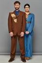 stylish couple posing in tailored suits