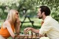 Stylish couple in sunglasses playing chess