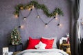 Stylish cozy Christmas bedroom with a large bed and decor Royalty Free Stock Photo