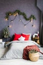 Stylish cozy Christmas bedroom with a large bed and decor Royalty Free Stock Photo