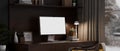 Stylish and cozy home working space with computer mockup and decor on stylish wooden desk Royalty Free Stock Photo