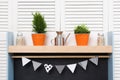 Stylish cozy kitchen shelf and blinds. Orange buckets with room