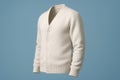 a stylish cream-colored cardigan with a v-neck and button-down closure, presented against a soft blue backdrop in a studio setting Royalty Free Stock Photo