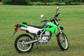 Stylish cross motorcycle on green grass outdoors