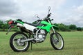 Stylish cross motorcycle on green grass outdoors