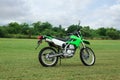 Stylish cross motorcycle on green grass outdoors