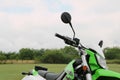 Stylish cross motorcycle on green grass outdoors