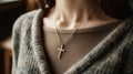 a stylish cross pendant necklace in a realistic photo, highlighting its timeless elegance and versatility as a fashion