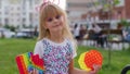 Stylish cute child kid girl showing squishy silicone touch screen bubbles pop it sensory game toys
