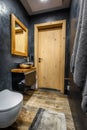 Dark bathroom interior with shower. Tiles imitating wood on the floor and on the wall Royalty Free Stock Photo