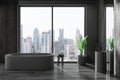 Stylish dark home bathroom interior with sink and bathtub, panoramic window