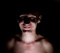 Stylish dark portrait of caucasian man who smiles like a mad or crazy Royalty Free Stock Photo