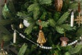 Stylish decorated christmas tree with vintage golden baubles and candles. Atmospheric winter holidays preparation. Modern Royalty Free Stock Photo