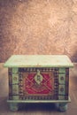 Stylish decorated old chest with beige background, brown wall with texture. Empty space for text, Vintyge style Royalty Free Stock Photo