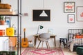 Desk and chair in workspace in vintage genderless kid room Royalty Free Stock Photo